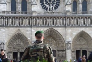 A French soldier patrols next to the Notre-Dame cathedral in Paris on December 24, 2015 as part of security measures set following the November 13 Paris terror attacks. / AFP / DOMINIQUE FAGET (Photo credit should read DOMINIQUE FAGET/AFP/Getty Images)