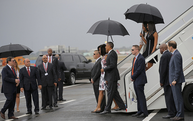 U.S. President Barack Obama and his wife Michelle approach Cuba's foreign minister Bruno Rodriguez (L) as they arrive at Havana's international airport for a three-day trip, in Havana March 20, 2016. REUTERS/Carlos Barria